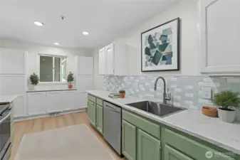 Updated kitchen with ample cabinet storage, wide counters, and an open layout to the dining and living room. Virtually Staged