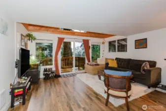 From this gorgeous living room, the slider invites you to step directly onto the deck for fresh air and relaxation