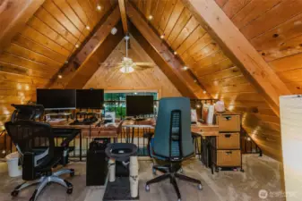 Thoughtfully planned, the cabin also provides a versatile area on the opposite side of the stairs—ideal for a home office, reading nook, or creative space.