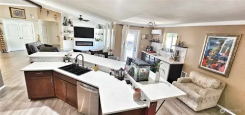 Kitchen flow to wet bar and out to large deck to easily entertain