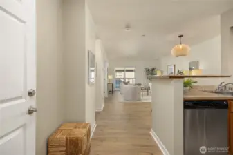 Sleek granite + stainless kitchen flows into a chill living room with a Juliet balcony, roomy primary suite, Pergo floors, elevator, controlled access and gated parking.