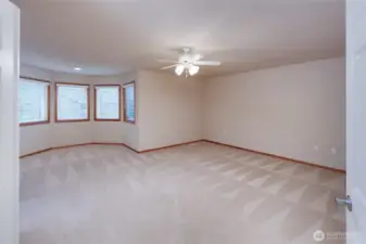 King sized primary retreat w/bay window seating area w/gas fireplace.