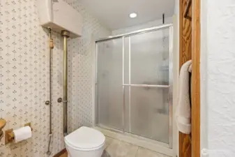 Main bath also features a high tank pull chain toilet and a separate shower.