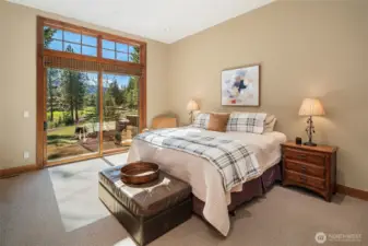 Main level bedroom with door to patio