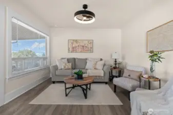 Living room with huge picture window, new flooring, and new paint