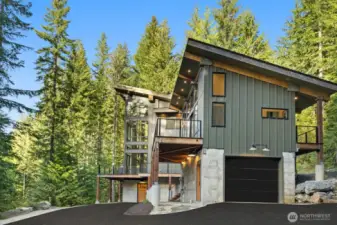 The main home stands nearly 50 feet tall with glass walls allowing amazing views of nature and tons of natural light. Just above the garage is a guest house, A great spaces for guest.