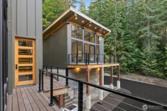Paved driveway makes for a clean look. Here you can see a good view of the front deck from the guest house. Guest house also have a rear deck. Your choice of where you want to enjoy the outside in the enchanting mountain home.