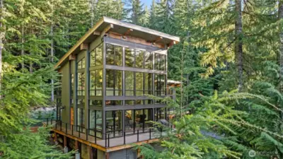 Absolutely stunning glass walls. While in this beautiful home you feel as if you are in a elegant tree house with glass wall all around you.