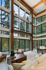 How wonderful would it be to enjoy time in this living room. Soaking in the evergreens and the view.