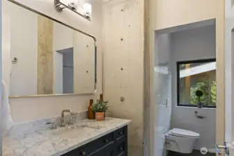 The primary bedroom bath has heated floors, like the rest of the house, and an elegant European bath and huge shower.