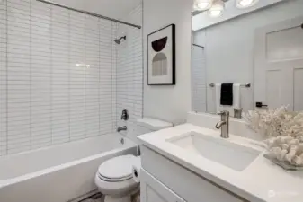 Bathroom featuring classic subway tiles and a skylight, bringing in abundant natural light and a sophisticated touch.