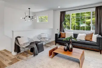 Beautiful living room with expansive windows, bathing the space in abundant natural light and creating a bright, airy atmosphere.