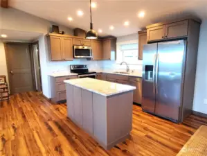 Granite counters, center island and stainless steel appliances.