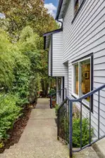 Walkway from the mailbox and parking area. The homes can be accessed from the front of the building or from the back.