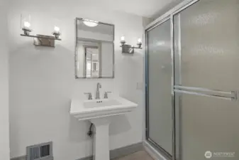 Lower-level 3/4 bath offers everyday convenience with practical design and functionality.
