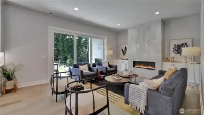 This stunning great room is accented with a modern gas burning fireplace and built in cabinets...all with open access to the outdoor entertaining area.