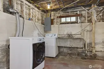 Laundry & large utility sink in unfinished basement