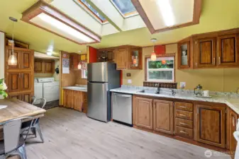 The kitchen is large enough for a dining table and is connected to the utility area and back porch.