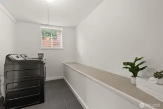 Laundry room located right off the bonus area on the lower level.