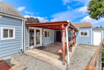 Covered patio with outdoor speakers and lighting