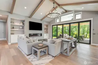 Living Room featuring quality lighting, built-in shelving, gas propane fireplace.
