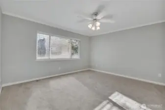 Master bedroom, the large window for natural light, molding ceiling and the ceiling fan with its overhead lighting.