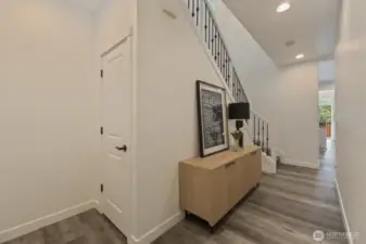 From this angle the entryway shows also the stairs going up to the 2nd floor and the rod iron balusters