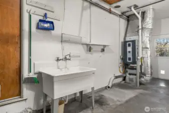 1 Car garage doubles as shop with storage and deep sink.