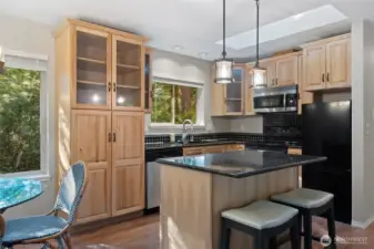 Kitchen w/eating island, solid counters looks toward private back yard.