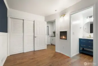Second bedroom w/it's own half bath & wall fireplace,  toward hallway and side door.