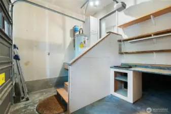 Golf-cart sized garage/shop with lots of storage on slab.