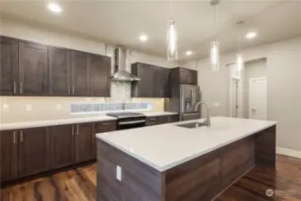 Beautiful soft close cabinetry, exquisite lighting and a massive entertainment bar with gleaming quartz countertops offer so much space for the gourmet chef or simple snack times