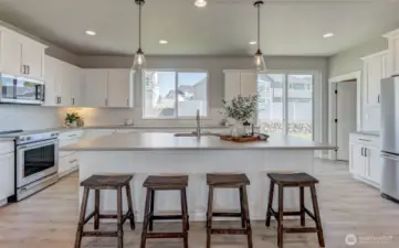 Slider off the kitchen to the back yard as well.. Walk in pantry to the right.
