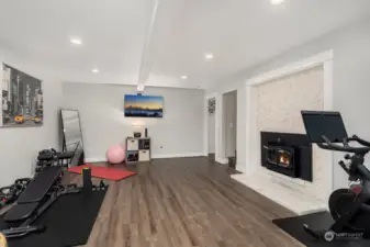 Huge rec room with fireplace, perfect for home gym.