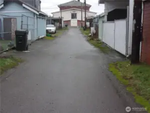 Paved alley access to the back of the property.