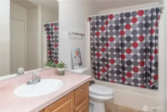 Hallway bathroom. On the right side, there is a door to the laundry