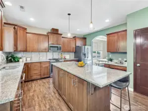 Plentiful granite counter space, outlets & storage make this kitchen perfect for the chef in your life.