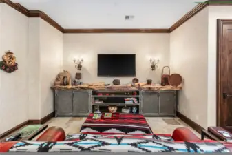 Custom built entertainment area separate from living room topped with 13 foot white oak slab