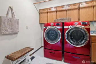 Main level laundry with sink and large cabinet space