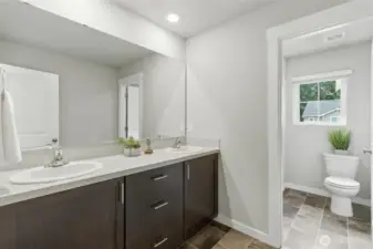 Upper level full bathroom with double sink and generous counter space