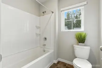 Upper level bathroom full bath and toilet features separate room with pocket door.