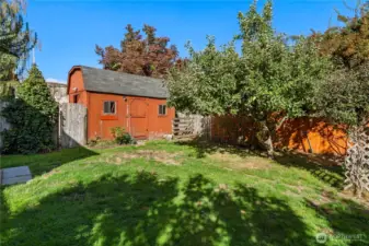 The yard is beautifully screened and private, with mature trees.