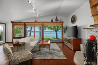 Side door from living room to side yard, back covered patio, flat grass yard and your beautiful beach.