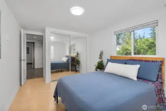 2nd bedroom with laminate wood flooring.