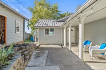 Side courtyard patio with storage building for wood and garden supplies.  Door to kitchen.