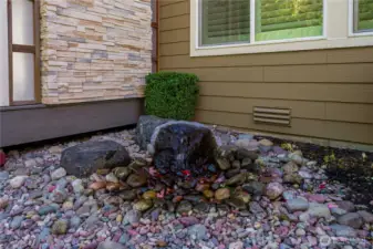Soothing water feature sets a tranquil backdrop.