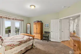 Primary suite with french doors leading out to the expansive composite deck.