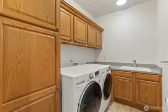 Main floor laundry with plenty of storage and a utility sink.  Solar tube brings in extra light.