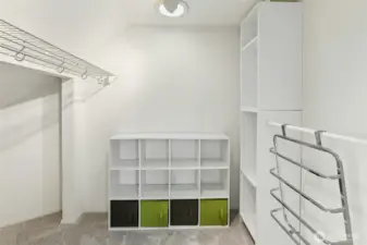 Walk-in-closet with solar tube for natural lighting attaches to primary bedroom.