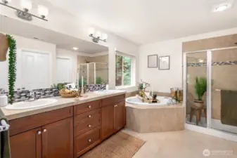 Five-piece ensuite bath  and a large walk-in closet with custom built-in storag
